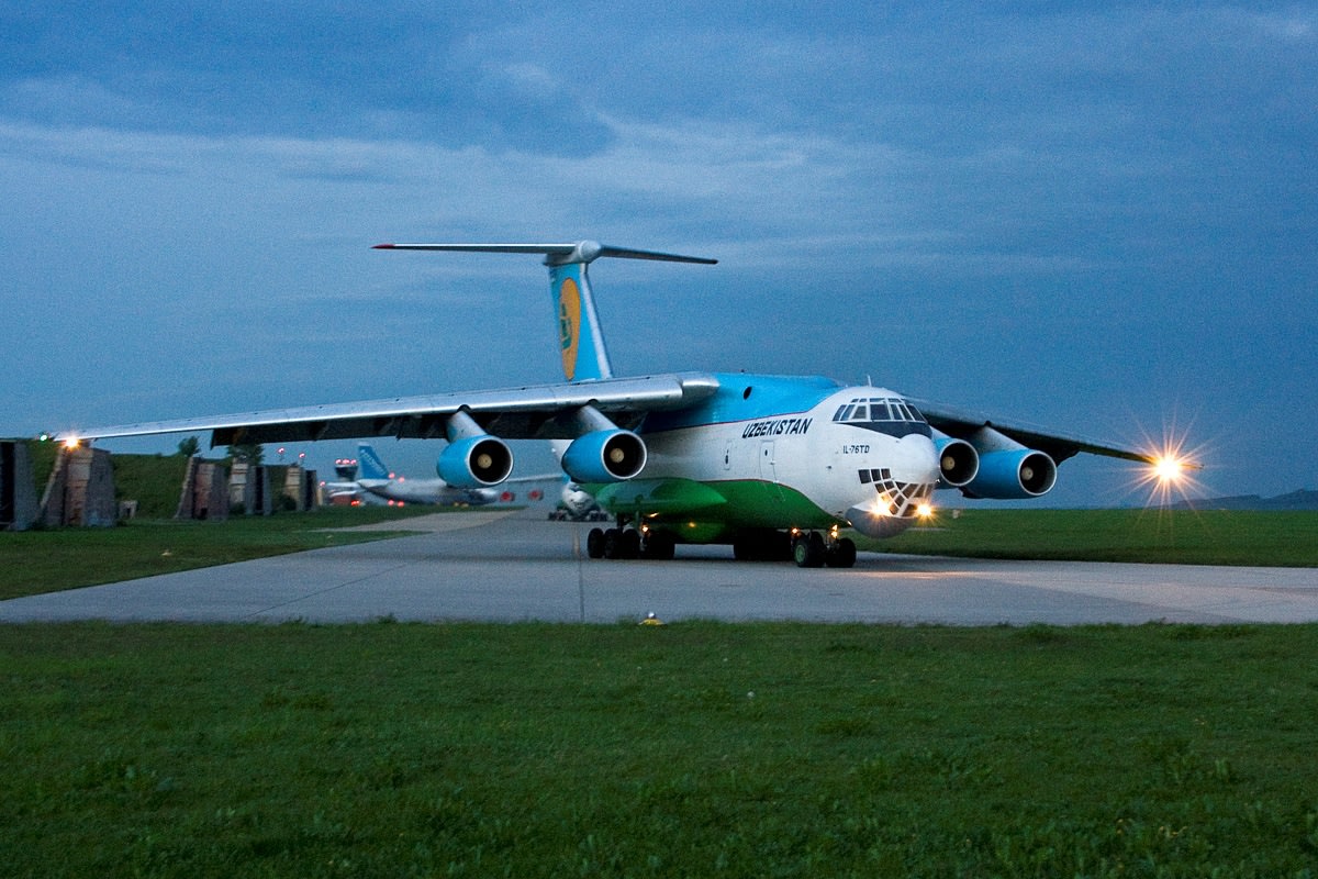 An Uzbekistan Il-76TD freighter taxiing at dusk